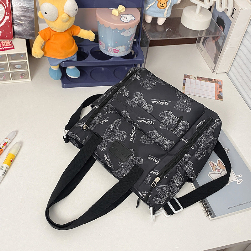 Size reference for the Everyday Bear crossbody tote bag, 11.8 x 11.8 x 1.6 inches